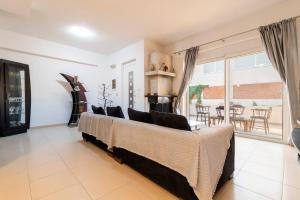 a living room with a couch and a large window at Dolphins maisonette Rhodes in Ialysos