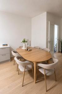 a dining room with a wooden table and chairs at The Nordic - 2BR in Voss - The Voss Collection in Vossevangen