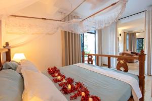 a bedroom with a bed with christmas decorations on it at Diani Luxe Villa in Mombasa