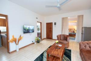 a living room with a couch and a table at Diani Luxe Villa in Mombasa