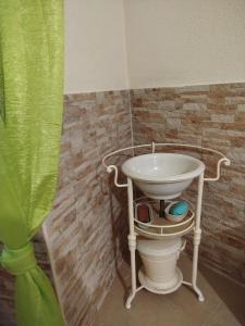 a bathroom with a white sink and a toilet at Casa Bia Olívia in Albernoa +9 photos
