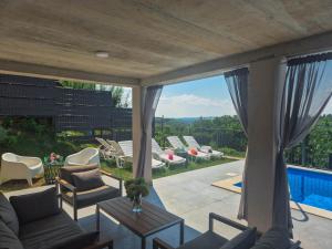 a view of a patio with chairs and a pool at Casa Kapela in Donji Koncovčak