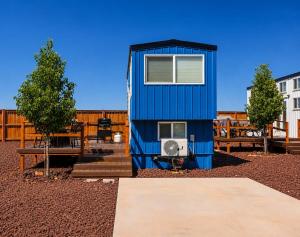 a blue tiny house sitting on top of a yard at Zion Tiny Home, Hot Tub, Gooseberry Mesa Trails in Apple Valley +22 photos