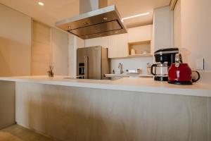 a kitchen with a red appliance sitting on a counter at Modern apt with 2 BR BBQ and views in Cartagena de Indias