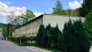 a building with trees in front of it on a street at Ubytování U Hráze in Liberec