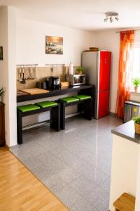 a kitchen with a red refrigerator and a counter at Ferienwohnung Schaftnach Rednitzblick nähe Messe in Schwabach