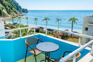 a balcony with a table and chairs overlooking the ocean at Blue Stay Boutique Hotel in Himare