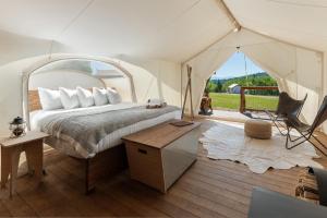 a bedroom with a bed in a tent at Under Canvas White Mountains in Dalton