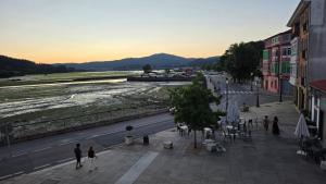 a group of people walking down a city street at Luxury Ría Noia in Noya