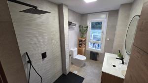 a bathroom with a sink and a toilet and a window at Luxury Ría Noia in Noya +42 photos