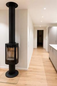 a black stove in the middle of a room at The View - 4BR Central Voss - The Voss Collection in Vossevangen