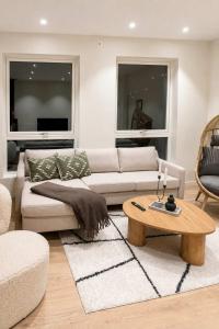 a living room with a couch and a coffee table at The View - 4BR Central Voss - The Voss Collection in Vossevangen