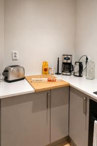 a kitchen with a cutting board on a counter at The View - 4BR Central Voss - The Voss Collection in Vossevangen +32 photos