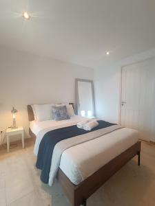 a bedroom with two beds and a mirror on the wall at Tomarhousing - Style in Tomar