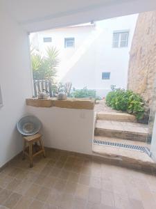 a room with a window and a table and stairs at Tomarhousing - Style in Tomar