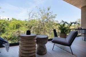 a patio with a table and chairs and a window at Interior designers second home FREE BIKES in Tulum