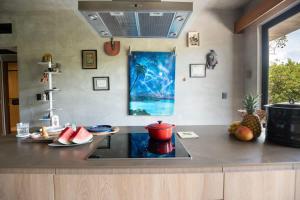 a kitchen with a counter top with a stove top at Interior designers second home FREE BIKES in Tulum +26 photos