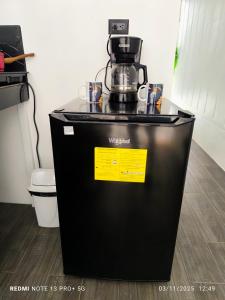 a coffee maker sitting on top of a refrigerator at Tucan container in Fortuna +11 photos