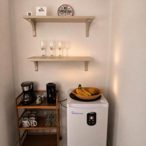 a small refrigerator with a bowl of bananas on top of it at Portal de Santa Maria in Santa Maria +11 photos