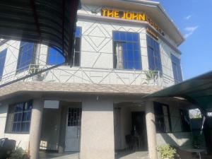 a building with a sign on the front of it at The John's Park in Mwanza