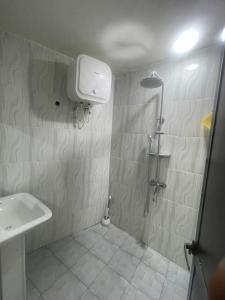 a bathroom with a shower and a sink at The John's Park in Mwanza