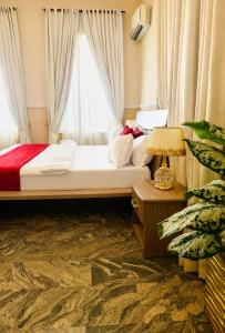 a bedroom with a large bed with a window at The Castle Private Villa in Aso