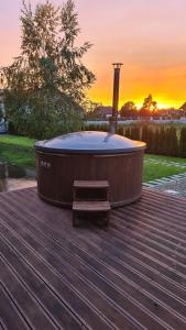 a hot tub sitting on a deck with a bench at SHKLO Lake&SPA in Shklo +23 photos