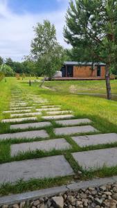 a stone path in a field with a building in the background at SHKLO Lake&SPA in Shklo
