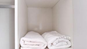 a room with white towels in a closet at SAOB Property- South A in Germiston