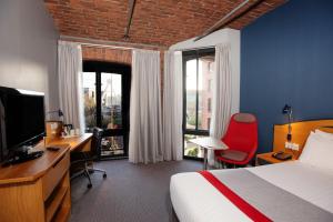 a hotel room with a bed and a desk and a television at Holiday Inn Express Liverpool-Albert Dock by IHG in Liverpool