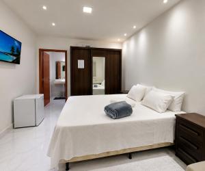 a bedroom with a large bed with a pillow on it at Suíte com Jacuzzi Vista de Escarpas 4 in Capitólio