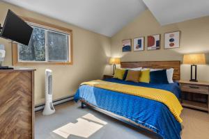 a bedroom with a bed and a television at Ski House 235 - Bend Comfy Condo in Bend +51 photos