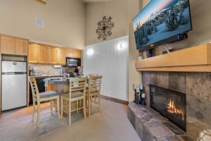 a kitchen and dining room with a fireplace at Ski House 235 - Bend Comfy Condo in Bend