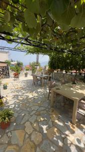 a stone patio with tables and chairs and plants at Saymon apartment Trpejca in Ohrid
