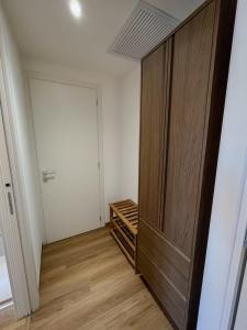 a closet with a wooden door in a room at Apartment-alys in Pordenone