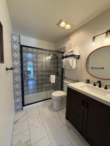 a bathroom with a toilet and a sink and a shower at Hotel Frisco in Frisco +42 photos