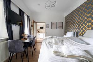 a bedroom with a bed and a table and a desk at Apartment at Main Square - 35 m2 - Netflix - Quiet in Leoben +11 photos
