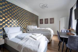 a hotel room with three beds and a table and a dining room at Apartment at Main Square - 35 m2 - Netflix - Quiet in Leoben