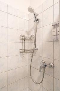 a shower with a shower head in a bathroom at Apartment at Main Square - 35 m2 - Netflix - Quiet in Leoben