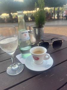 a table with a bottle of water and a cup of coffee at DADI Apartment in Linz am Rhein +7 photos
