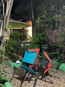 two chairs and a table in a garden at Charly's Place in Alajuela