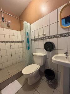 a bathroom with a toilet and a sink at Charly's Place in Alajuela +36 photos