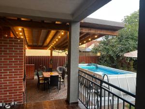 a patio with a table and a swimming pool at Rus House in Cluj-Napoca