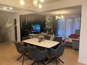 a living room with a table and some chairs at Rus House in Cluj-Napoca