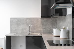 a kitchen with a sink and a counter top at 4 Bedroom modern apartment in Birkenhead