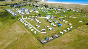 an aerial view of a group of cars parked in a field at Rainbow's End Yurts in Dornoch +1 photo