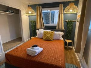 a bedroom with a bed with towels on it at Pet-Friendly Near Zion - Hot Tub Downtown Kanab in Kanab