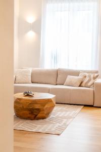 a living room with a couch and a wooden coffee table at Unique apartment with all comforts and sauna in Otepää