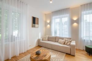 a living room with a couch and a table at Unique apartment with all comforts and sauna in Otepää