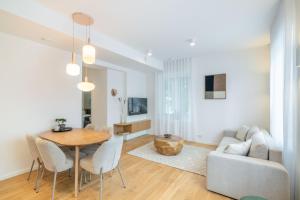 a living room with a table and a couch at Unique apartment with all comforts and sauna in Otepää